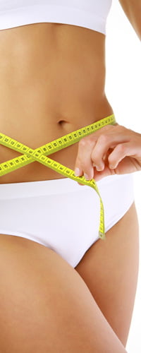 Measuring Tape Around A Woman's Stomach Photo - Cosmetic Surgery Center