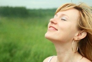 Woman Smiling With Her Head Tilted Up Picture - Cosmetic Surgery Center