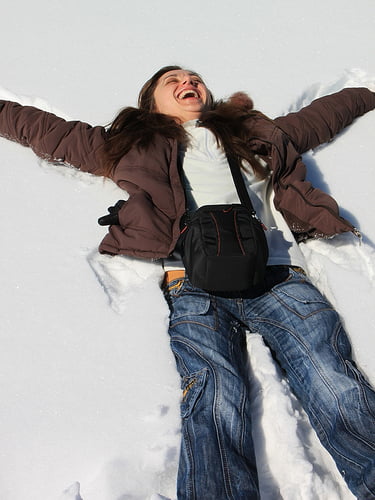Woman Laying In Snow Photo - Cosmetic Surgery Center