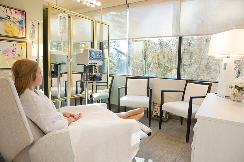 woman sitting in comfortable chair at exhale medical spa
