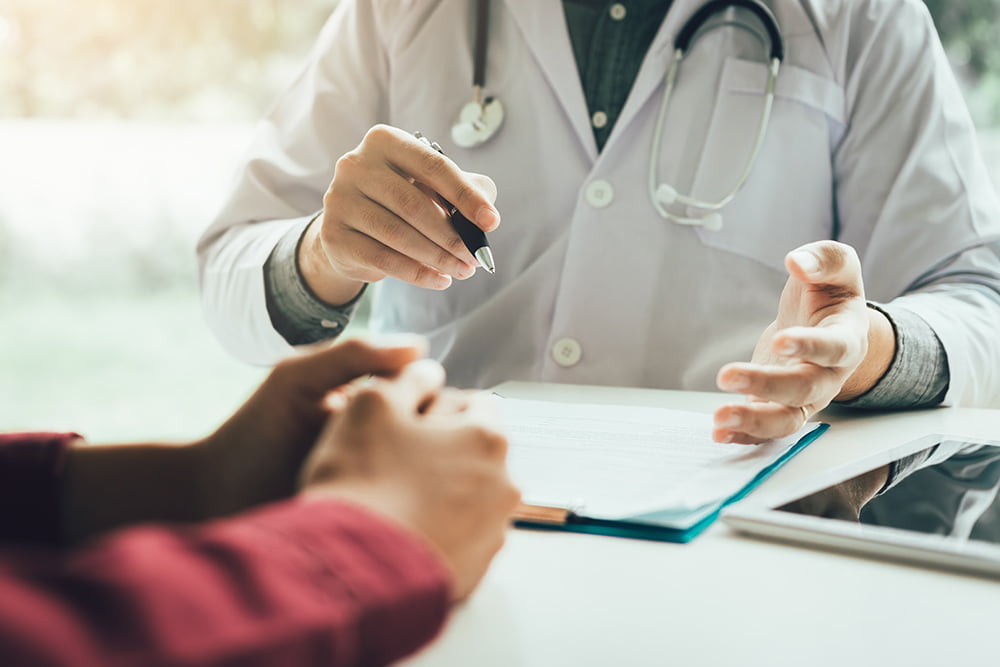 photo of doctor meeting with patient