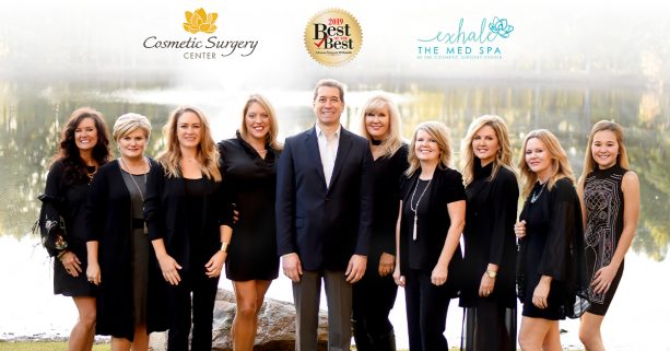 Dr. Branman and the Cosmetic Surgery Center team posing by a lake