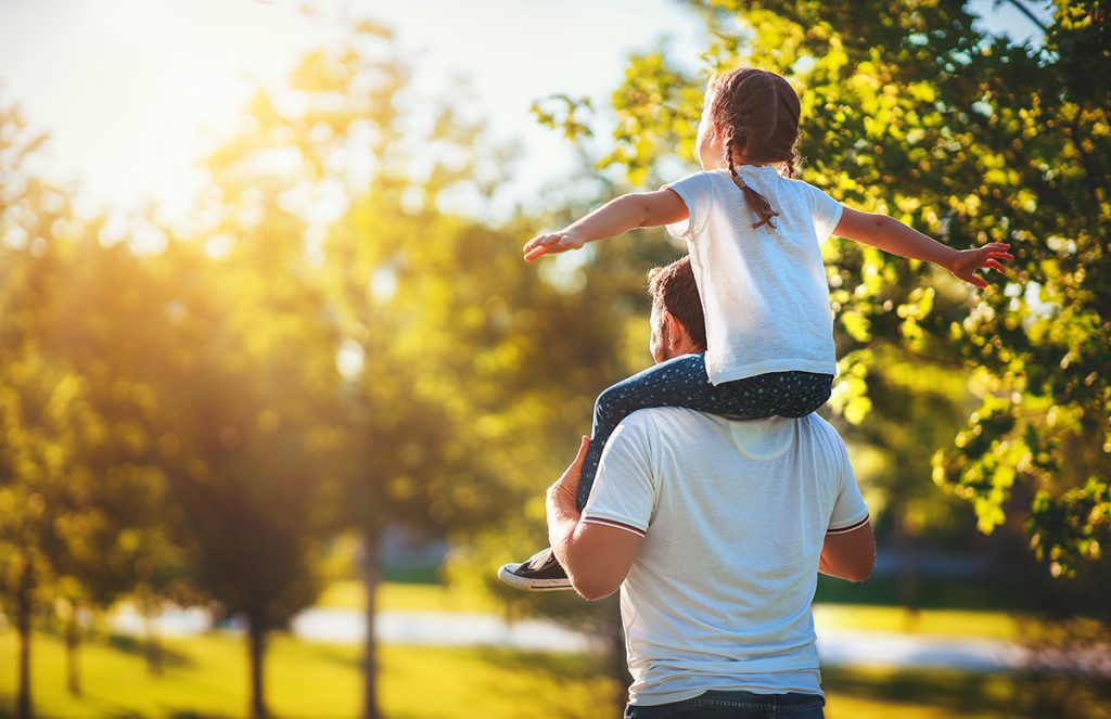 dad with child on shoulders 