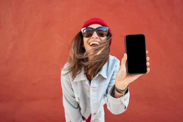 Young Girl Poses by Wall with Phone for Instagram in Little Rock