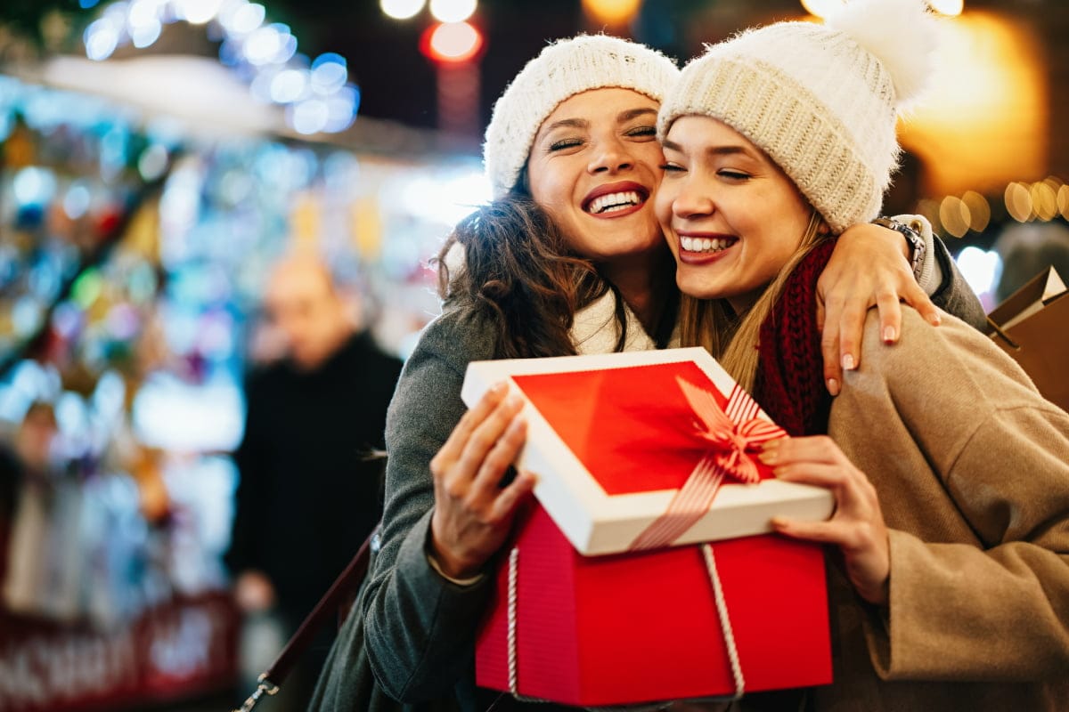 Two friends exchanging Christmas gifts in Little Rock