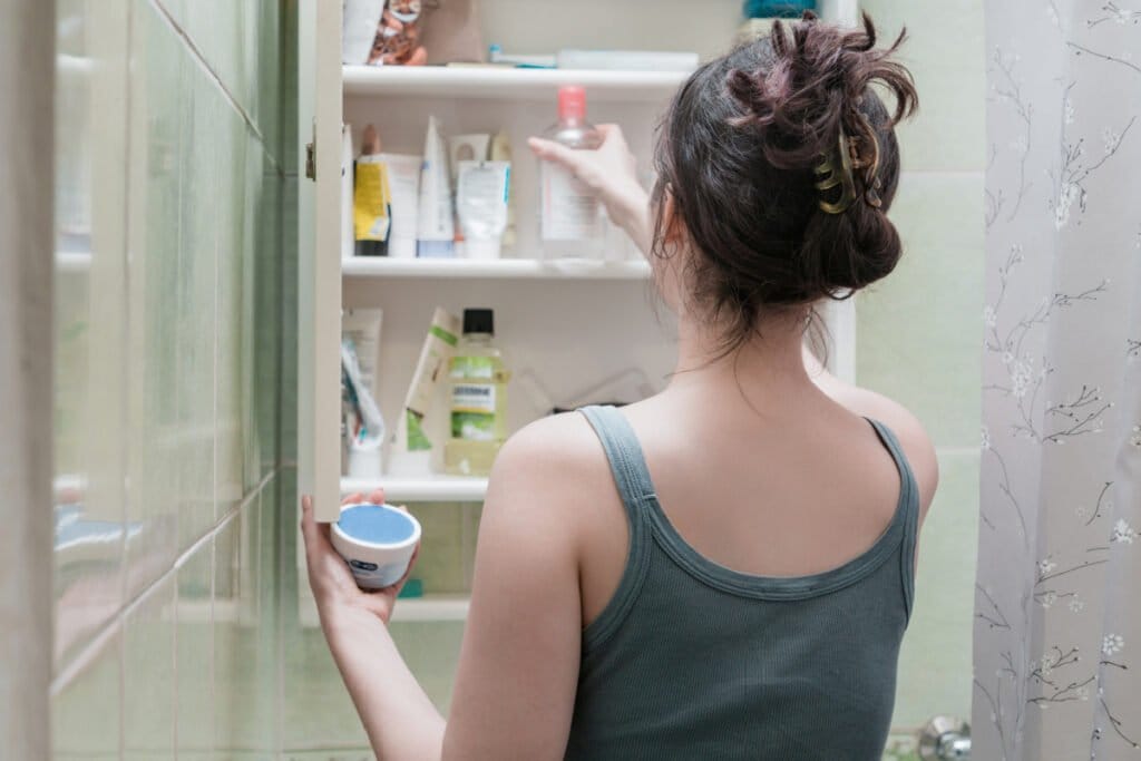 Woman going through her skincare collection