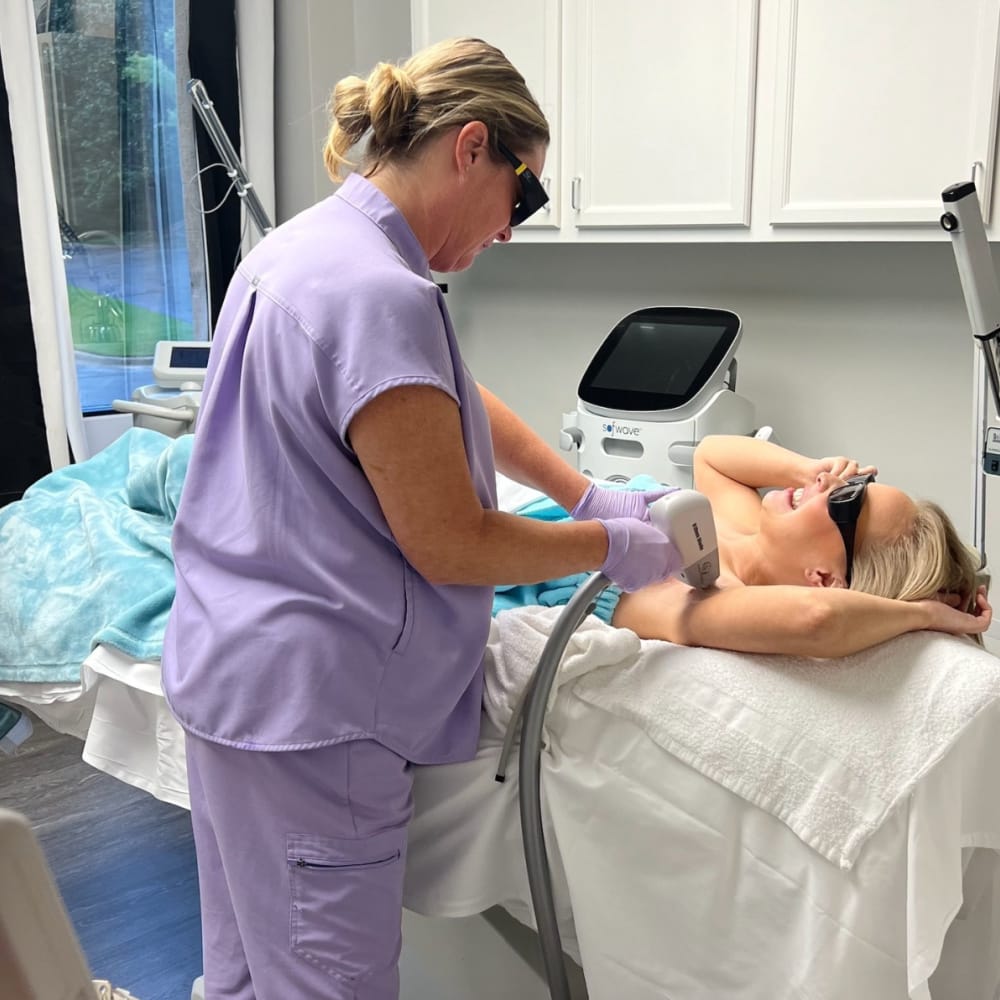 Our licensed aesthetician performing laser hair removal our Exhale Med Spa