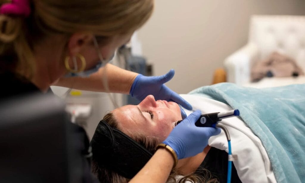 A provider performing a HydraFacial MD treatment
